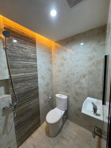 a bathroom with a toilet and a shower and a sink at Omah Tentrem Magelang in Magelang +13 photos