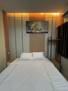 a bedroom with a large white bed in it at Omah Tentrem Magelang in Magelang