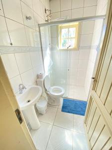 a small bathroom with a toilet and a sink at Apto com garagem em Diamantina in Diamantina