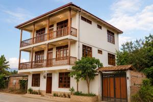 a large white house with a balcony at Casa campo in Lamas