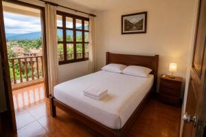 a bedroom with a bed and a large window at Casa campo in Lamas