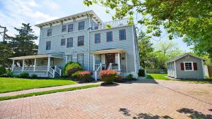 a large blue house on a brick driveway at Summer Winds Sanctuary in Cape May
