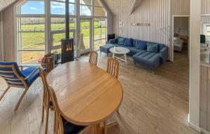 a living room with a table and a couch at Holiday Home Asperup 55 in Asperup