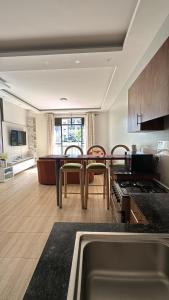 a kitchen with a table and chairs in a room at Pearl Escape in Entebbe