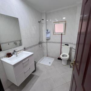 a bathroom with a sink and a toilet at Apparemment marina smir in Marina Smir +9 photos