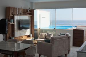 a living room with a view of the ocean at Ohana's Beach House in Punta Negra