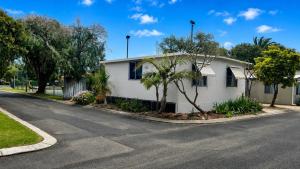 a white house on the side of a street at At Busso Cabin 56 in Broadwater