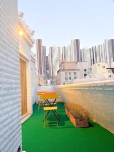 a patio with a table and chairs on a balcony at Fine On Stay Jeonpo in Busan