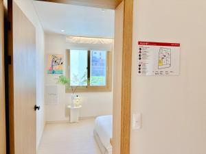a bedroom with a bed and a window at Fine On Stay Jeonpo in Busan +91 photos