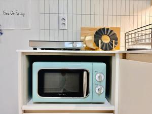 a microwave sitting on top of a shelf at Fine On Stay Jeonpo in Busan