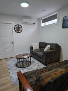 a living room with a couch and a table at Serene luxury apartment in Moncton