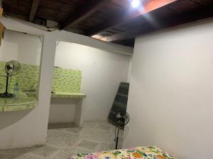 a room with a bed and a table and a chair at Marthita House in Puerto López