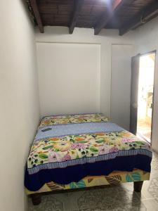 a bed in a corner of a room at Marthita House in Puerto López