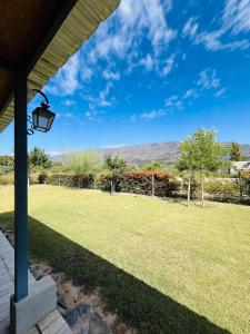 a view from the porch of a house with a lawn at Cina Cina, casita in Zonda