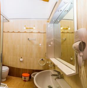 a bathroom with a sink and a mirror and a toilet at Residence Borgo Stella Marina in Bibione +34 photos