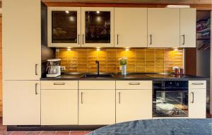 a kitchen with white cabinets and a sink at 2 Bedroom Stunning Home In Rømø in Rømø