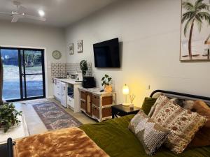 a living room with a couch and a tv in it at Shady Lane - Wallagoot in Jellat Jellat