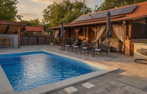 a swimming pool on a patio with a house at Stunning Home In Kutina With Sauna in Kutina