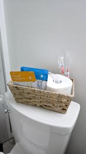 a basket on top of a toilet in a bathroom at Mountain Views, Premium Coquitlam Stay, Minutes to Transit in Coquitlam +31 photos