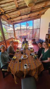 a group of people sitting around a long table at Pumaexplorer in Urubamba