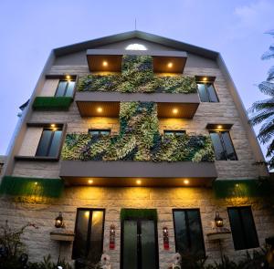 a building with a vertical garden on the side at The Marytara Residence in Sawah
