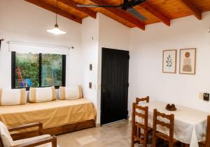 a bedroom with a bed and a table and chairs at El Cantaro in Villa Elisa