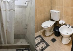a bathroom with a toilet and a shower at El Cantaro in Villa Elisa