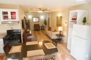 a kitchen and living room with a table and a refrigerator at Paradise Place Apartments in Mount Irvine