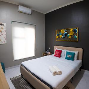 a bedroom with a large bed with towels on it at The Marytara Residence in Sawah