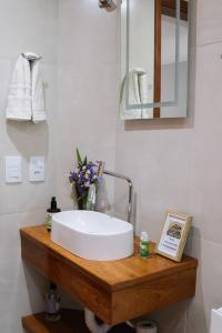 a bathroom with a white sink and a mirror at Casinha de Aldeia in Aldeia Velha