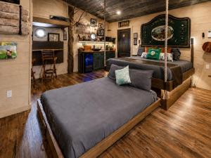 a bedroom with two beds and a kitchen in it at "The 19th Hole" Luxury Treehouse w Golf Views & Private 20ft Slide - 10 Miles from Dollywood in Sevierville