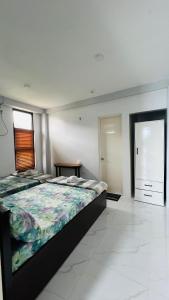a large bedroom with a large bed and a door at Belga Boarding House in Guimaras