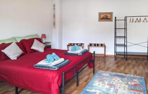 a living room with a red bed with towels on it at Ca' Piero in Lamon