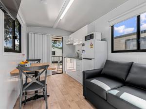 a kitchen and a living room with a couch and a table at BIG4 Casino Holiday Park in Casino