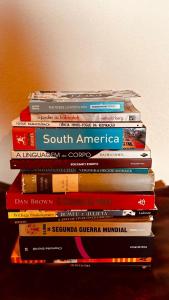 a stack of books stacked on top of each other at Casa Surya Paraty in Paraty