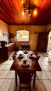 a kitchen with a wooden table in a room at Casa Surya Paraty in Paraty