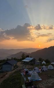 a group of tents on a hill at sunset at Nongkhiaw Camping 360 c top mountain view in Nongkhiaw