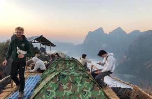 a group of people standing around a tent on a mountain at Nongkhiaw Camping 360 c top mountain view in Nongkhiaw