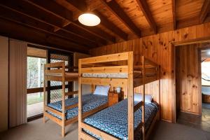 a bedroom with two bunk beds in a cabin at Possum Ridge in Muston +22 photos