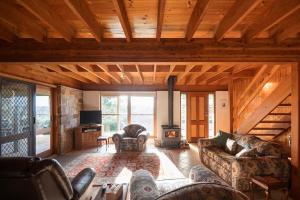 a living room with a couch and a fireplace at Possum Ridge in Muston
