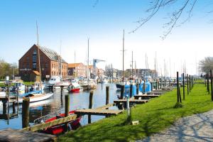 a group of boats docked in a marina with buildings at Ferienwohnung auf Fehmarn in Orther Reede in Orth