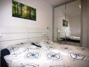 a bedroom with two beds and a mirror at Ferienwohnung auf Fehmarn in Orther Reede in Orth