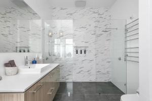a white bathroom with a sink and a shower at The Jetty, Port Willunga in Port Willunga +82 photos