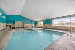 a large pool with blue water in a building at Best Western Plus Ocean View Resort in Seaside