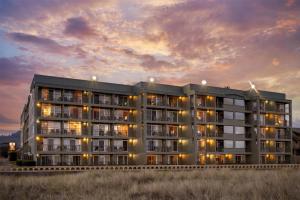 a rendering of a building at dusk at Best Western Plus Ocean View Resort in Seaside