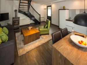 a living room with a couch and a table at Doppelhaushälfte im Naturresort Drewitz in Drewitz