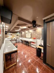 a large kitchen with tables and chairs in a room at Gumi stayraum in Gumi