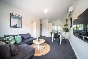 a living room with a couch and a table at Clouds on Francis - Cosy Comfort off Melbourne St in Bowden