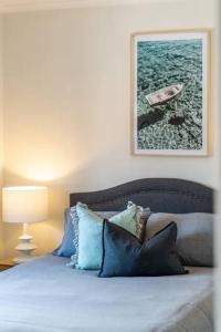 a bedroom with a bed with a picture on the wall at Clouds on Francis - Cosy Comfort off Melbourne St in Bowden