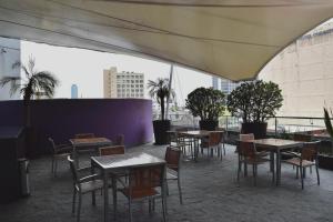 a group of tables and chairs on a roof at On Paseo de la Reforma, great location, luxurious, pool, gym in Mexico City